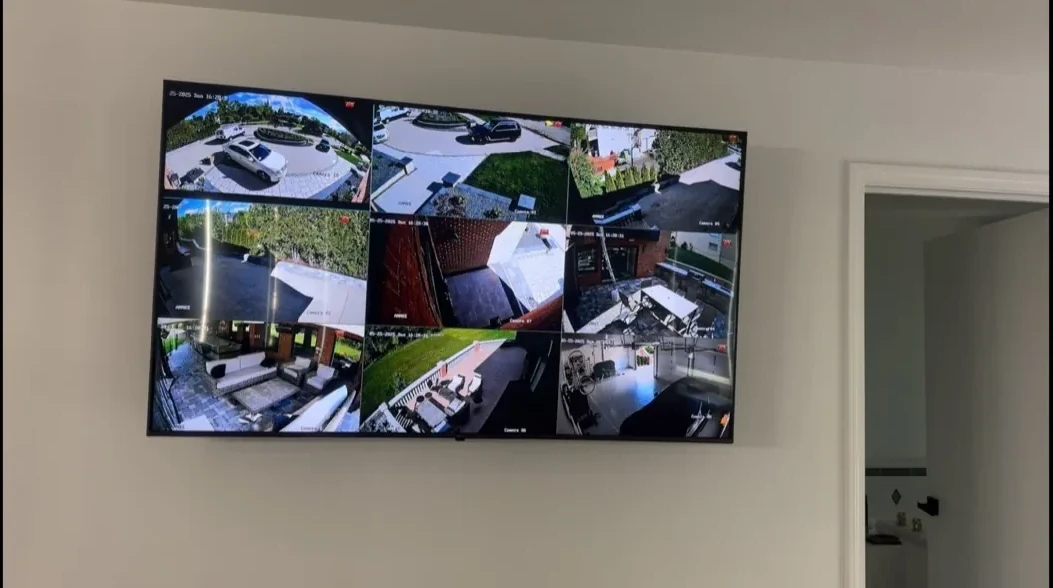 Wall-mounted display showing multiple security cameras